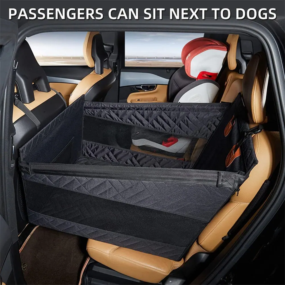 Black quilted fabric dog car barrier installed in the rear of a tan interior SUV