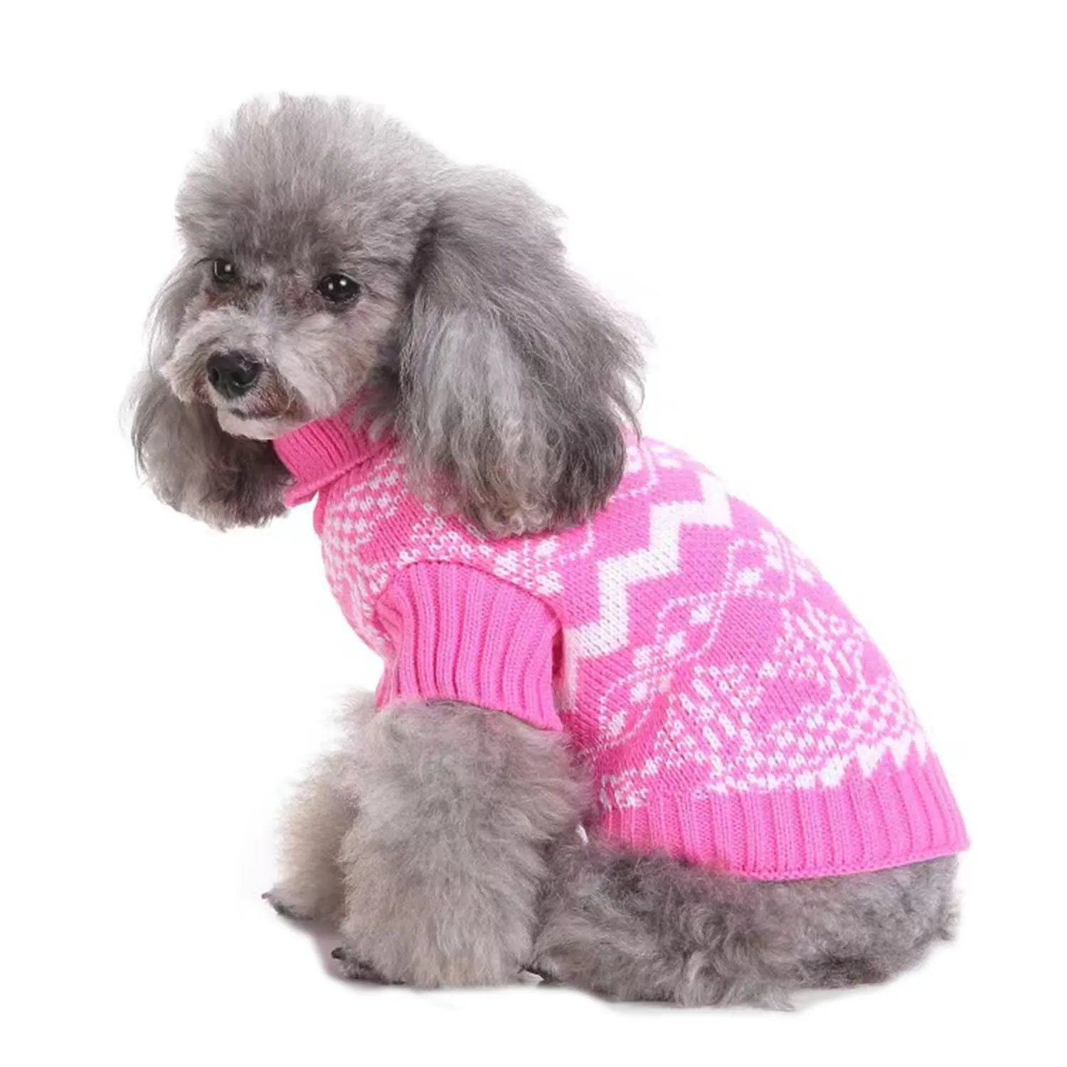 A gray poodle sitting in profile wearing a pink knitted sweater with white patterns.