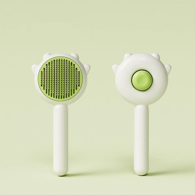 Front and back views of a white and green pet grooming brush with a handle.