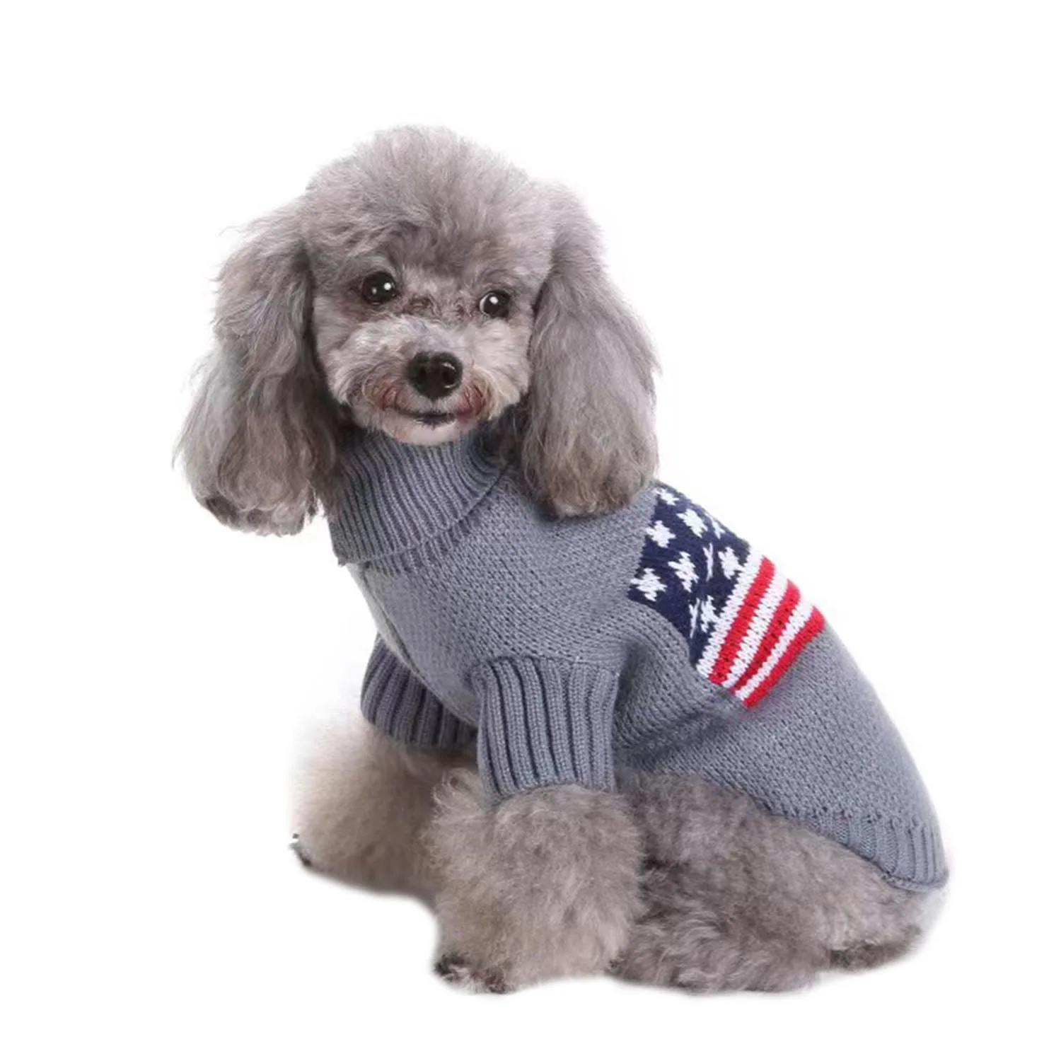 A grey poodle wearing a grey knitted sweater with an American flag pattern on the side.