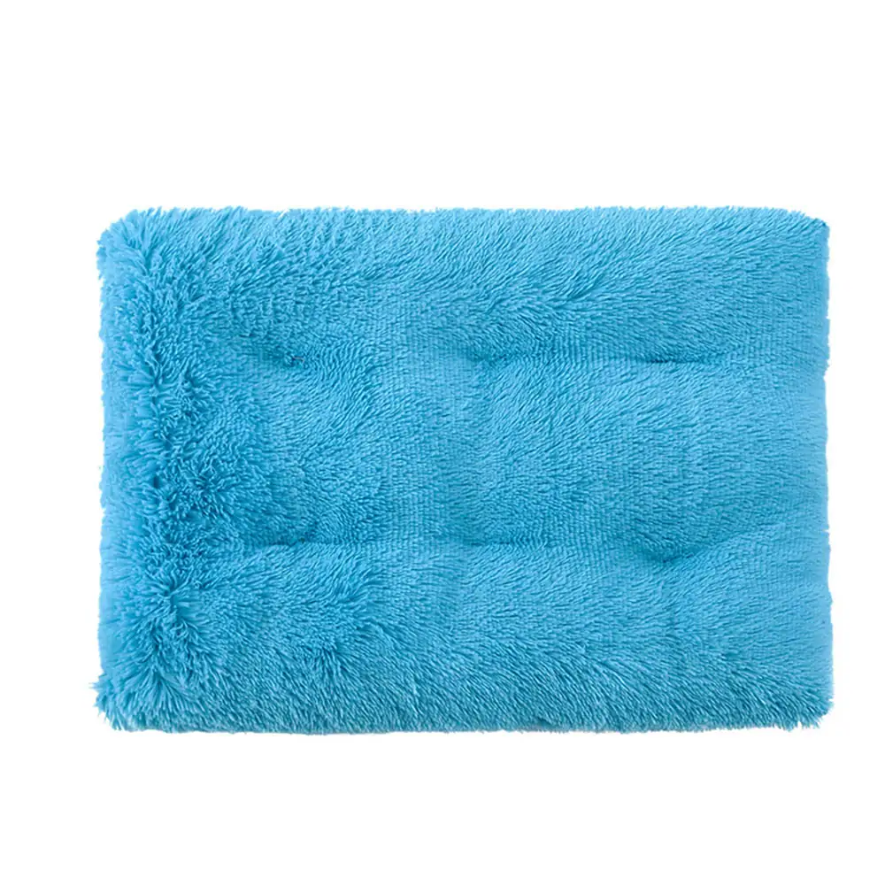 A rectangular turquoise shaggy rug with a plush texture on a white background.