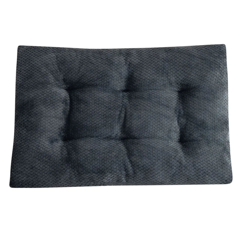 Dark gray tufted cushion with a textured fabric surface