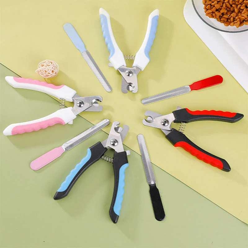 Multiple pet nail clippers and files arranged on a green background