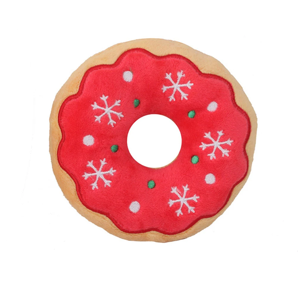 Red plush donut-shaped pet toy with white snowflake and green sprinkle details.