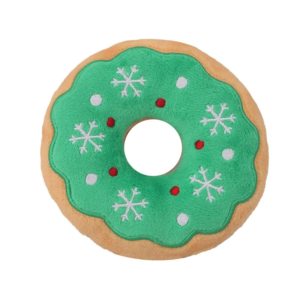 Plush donut pillow with green icing and embroidered snowflakes