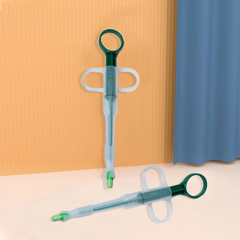 Two medical syringes with side wings and finger loops, one standing upright and one lying down.