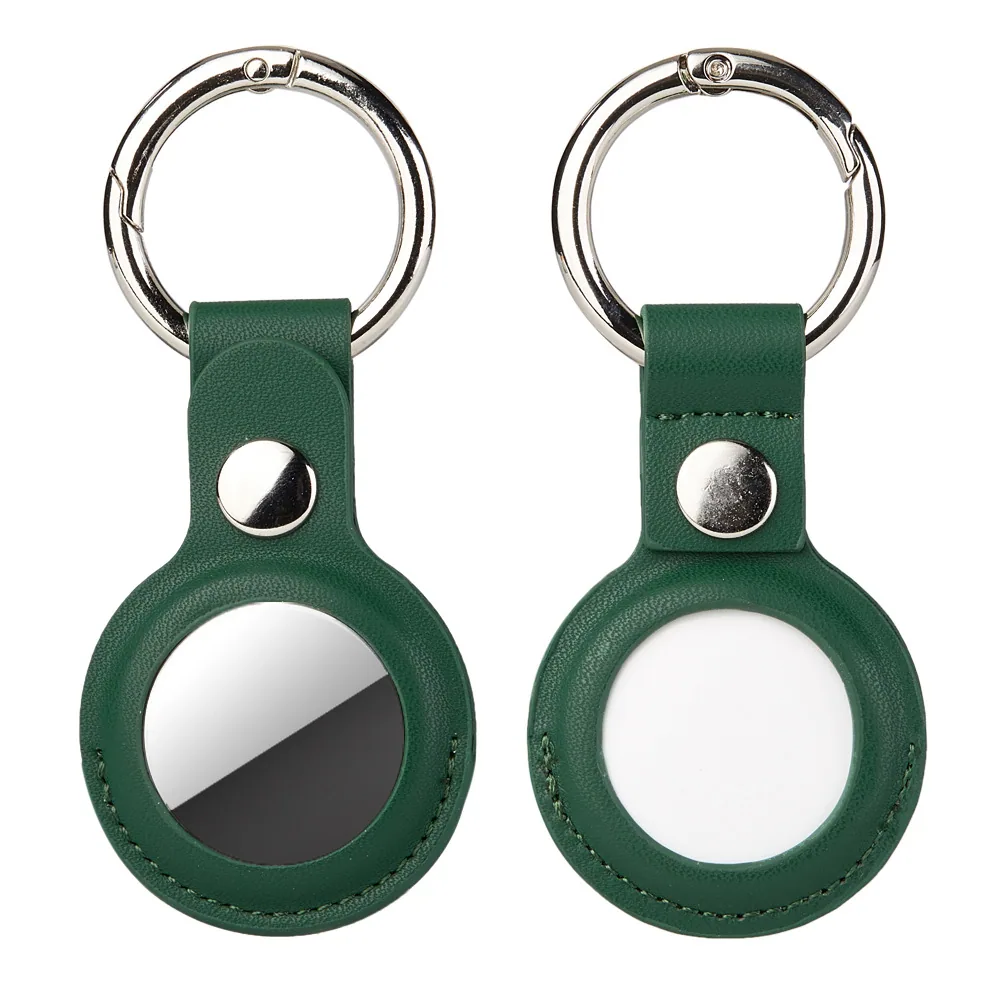 Two green leather keychains with metal rings and circular trackers on a white background