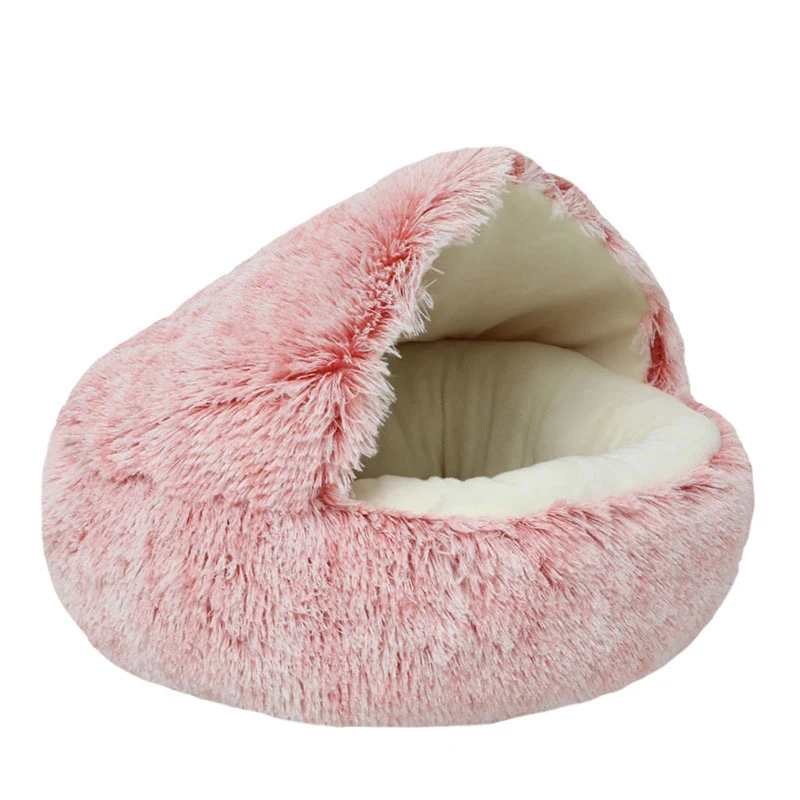 Pink fluffy pet bed with cream lining on a white background
