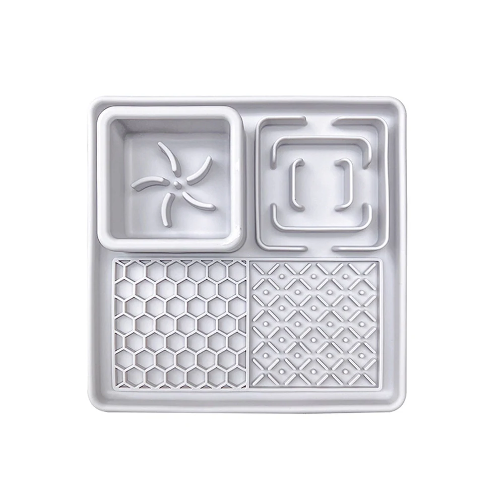 White plastic divided food tray featuring four compartments with star, square, honeycomb, and geometric textured patterns.