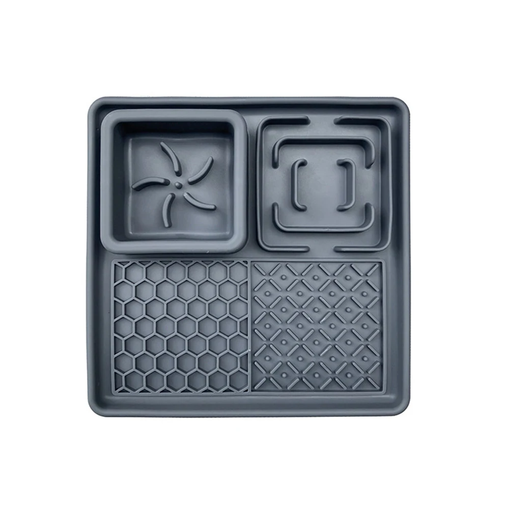 Grey silicone baking mold with four textured cavities on a white background