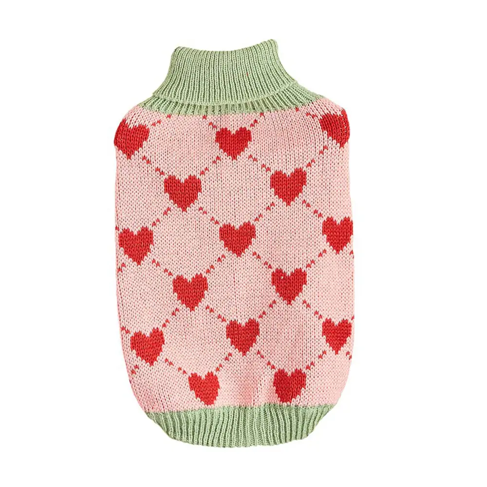 Pink knitted dog sweater with a red argyle heart pattern and ribbed green collar and hem.