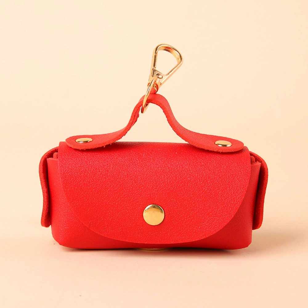Red leather keychain pouch with a gold clasp and snap button closure.