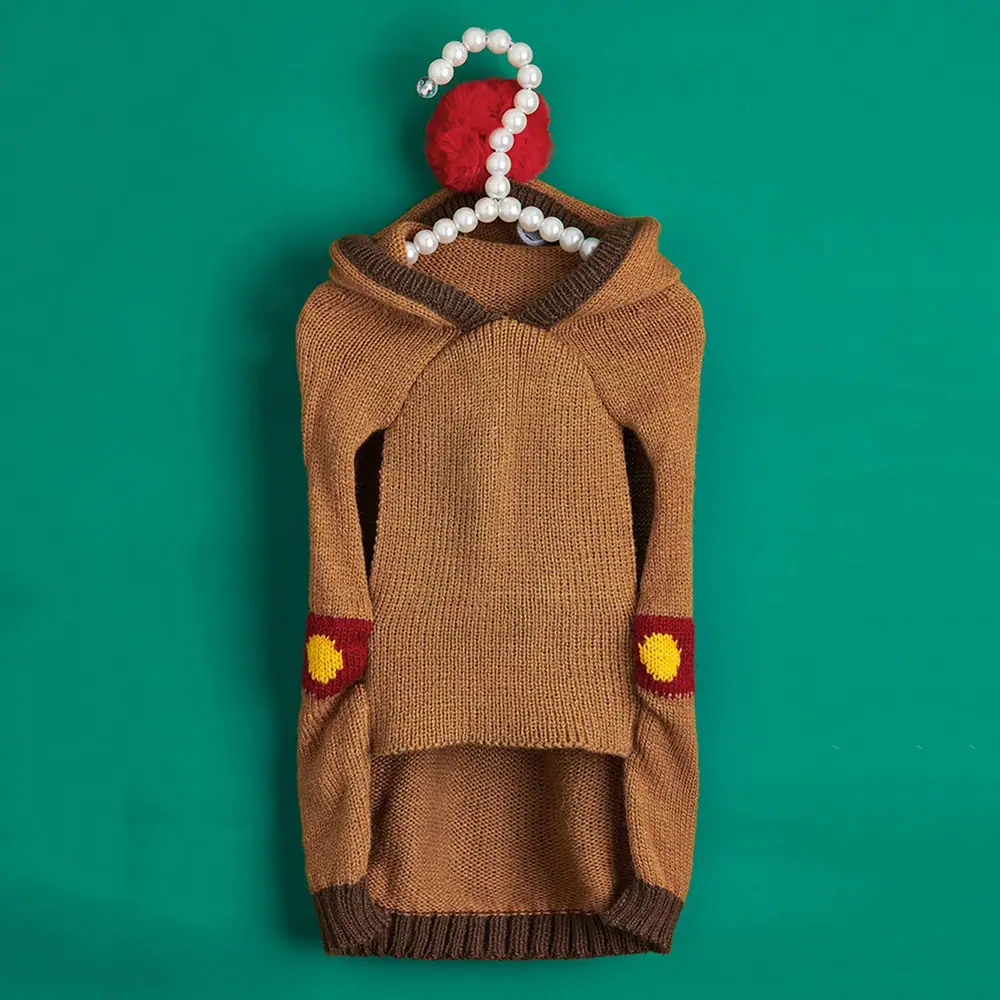 Brown knitted hoodie with red and yellow elbow patches on a hanger