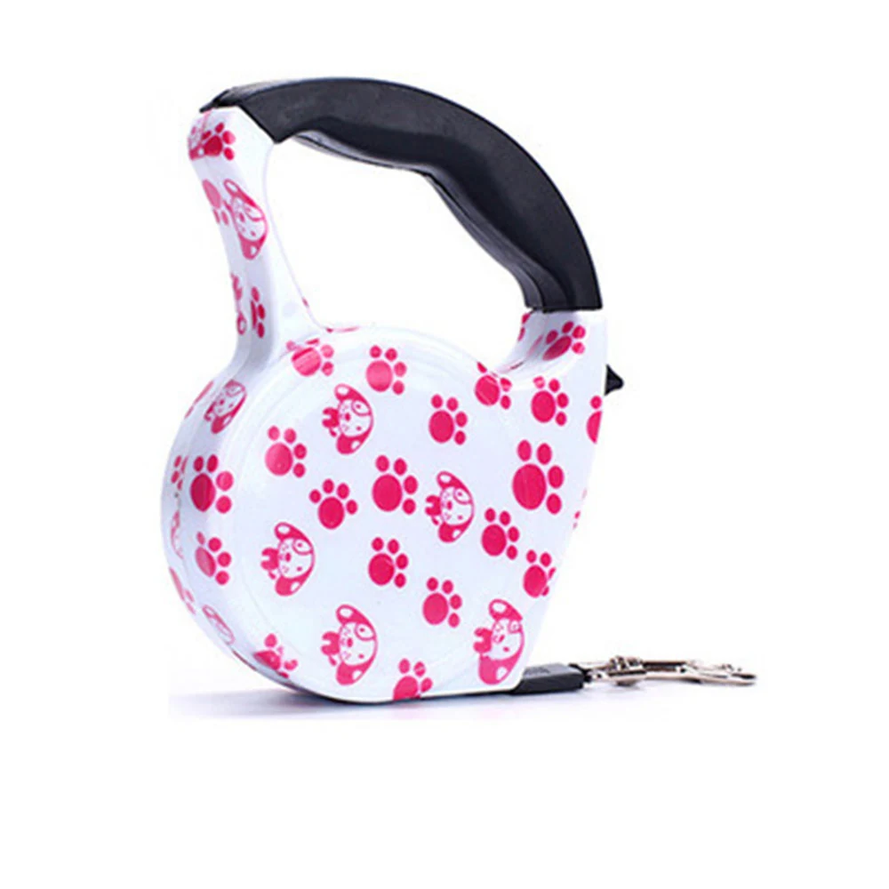 White retractable dog leash housing with pink paw print pattern and black handle