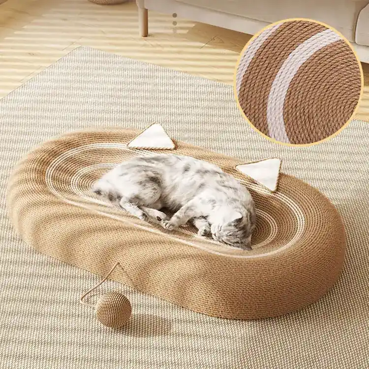 A cat sleeping in a woven sisal cat bed with triangular ear accents and an attached ball toy