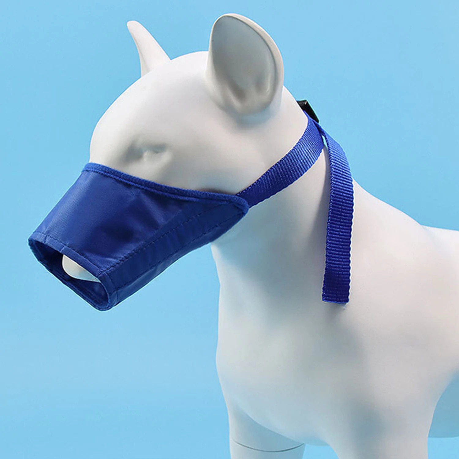 Blue dog muzzle displayed on a white mannequin head against a light blue background
