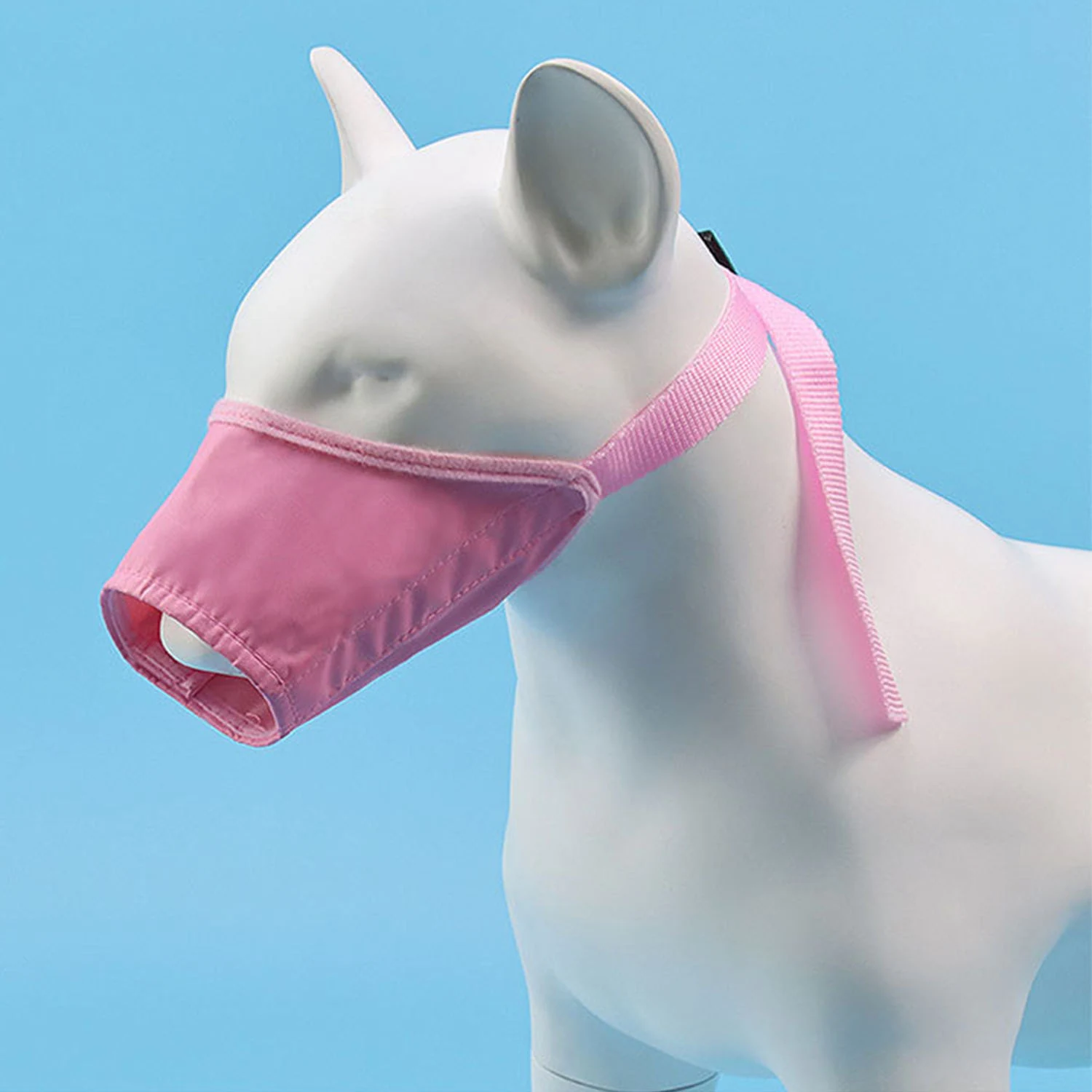 Pink dog muzzle displayed on a white mannequin head