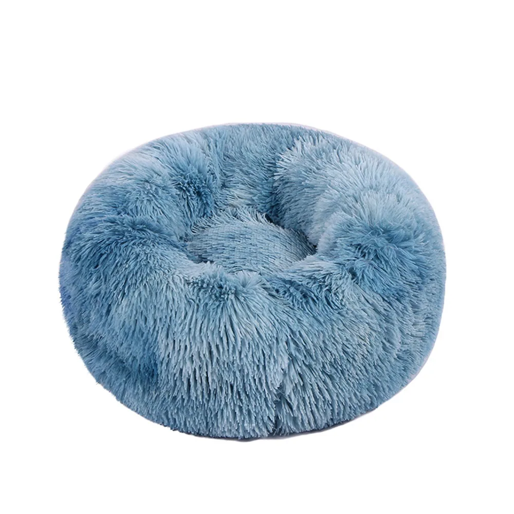 A round, plush blue faux fur pet bed or cushion on a white background