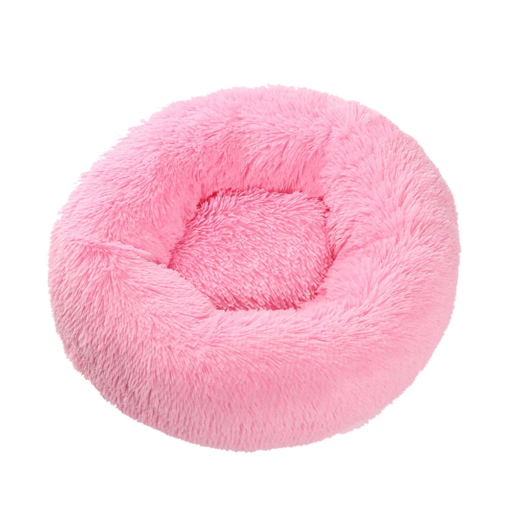 Plush pink round pet bed with raised rim and soft textured interior