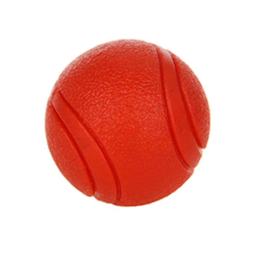 Red textured rubber ball with grooves on a white background