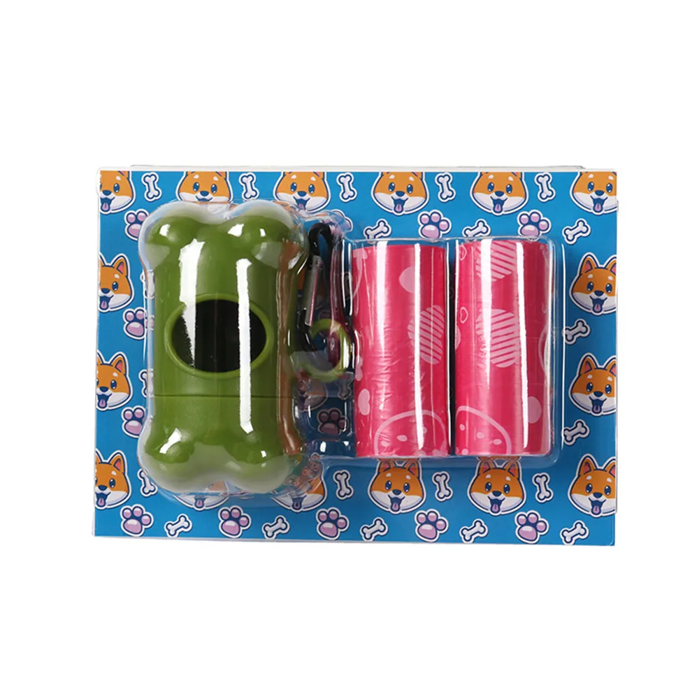 Retail blister pack containing a green bone-shaped dog waste bag dispenser and two rolls of red bags.