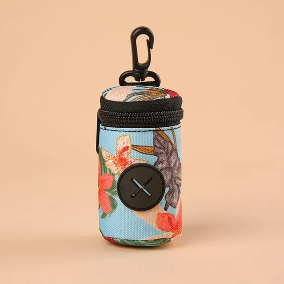 Small cylindrical fabric bag with floral pattern, black zipper, and carabiner clip.