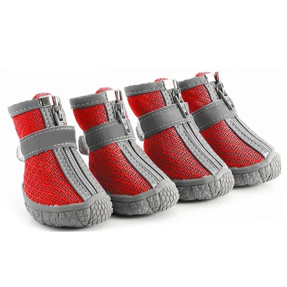 Four red and grey mesh dog boots with zippers and velcro straps arranged on a white background