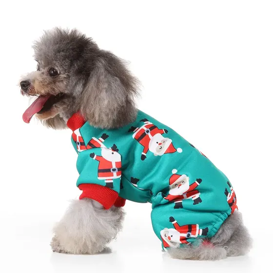 Gray poodle sitting in profile wearing a teal one-piece dog pajama with a Santa Claus print.