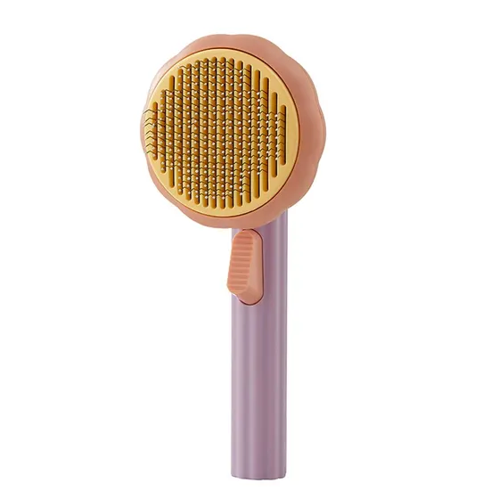Pink and purple round pet grooming brush with yellow bristles on a white background