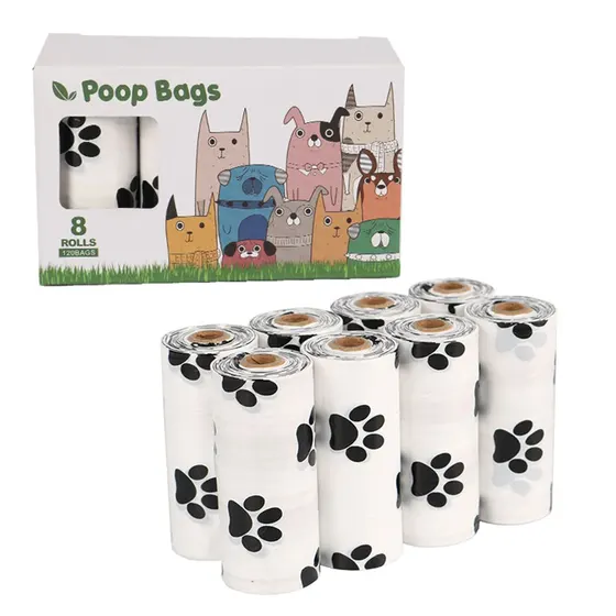 Retail box of 8 rolls of dog poop bags featuring cartoon dogs, with loose rolls displayed in front