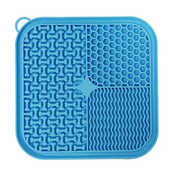 Blue silicone square mat with textured patterns including bones, hexagons, and waves, with a corner loop.