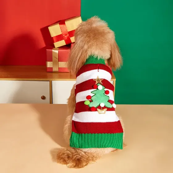 Back view of a dog wearing a red and white striped Christmas sweater with an applique tree