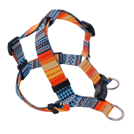 Colorful patterned dog harness with adjustable straps and metal rings on a white background.