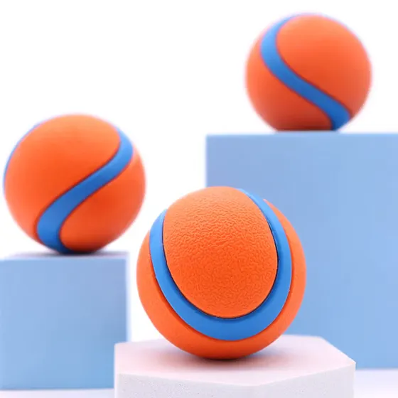 Three textured orange balls with blue curved stripes resting on geometric blocks