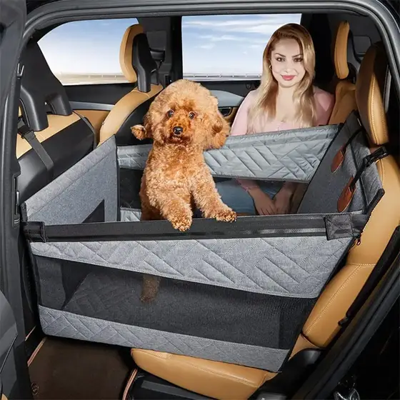 Grey quilted pet car seat cover with a brown poodle sitting inside, installed on a tan leather car seat.