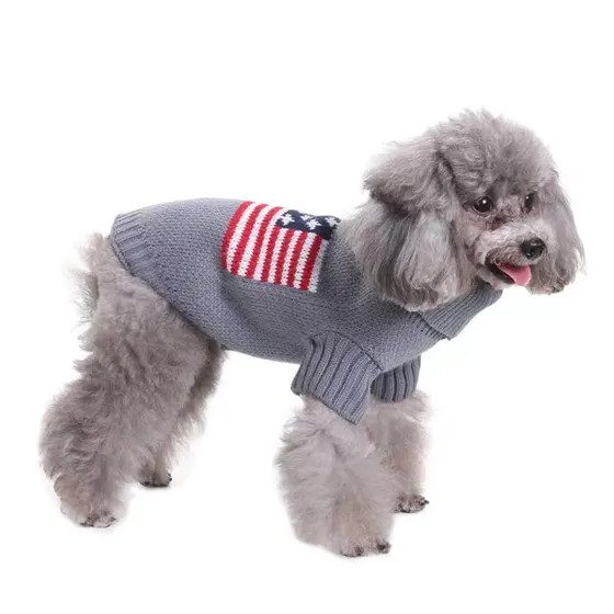 A gray poodle wearing a knitted sweater with an American flag pattern on the side.