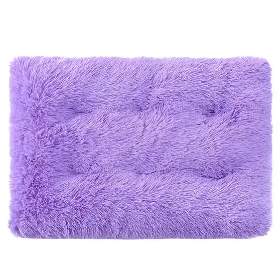 A rectangular purple tufted rug with a soft, shaggy texture and a buttoned pattern.