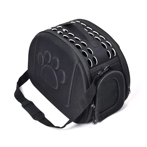 Black pet carrier bag with ventilation holes and a paw print design