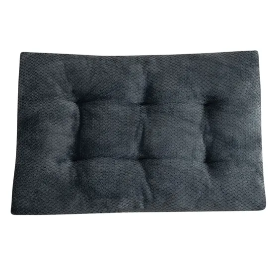 Dark gray tufted cushion with a textured fabric surface