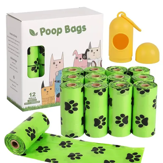 Pack of 12 rolls of green dog waste bags with paw prints, box packaging, and yellow dispenser.
