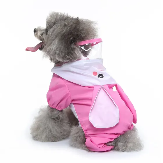 Grey poodle wearing a pink pet costume with a clear plastic hood and white face detail