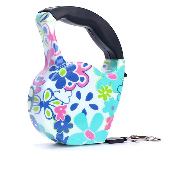 Retractable dog leash with black handle and floral pattern casing on white background