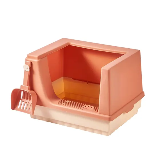 Peach colored enclosed litter box with a matching scoop attached to the side