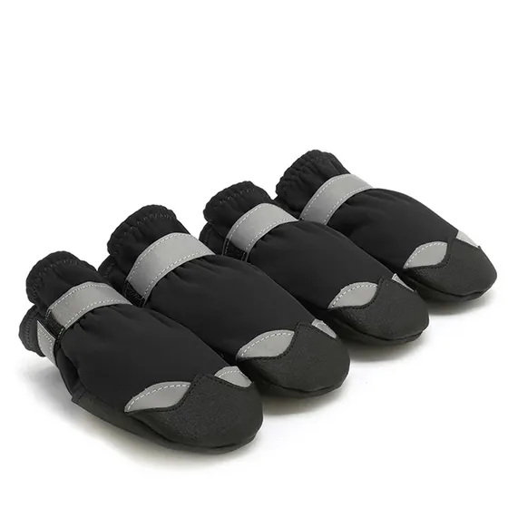 Set of four black and grey dog boots with reflective straps on a white background