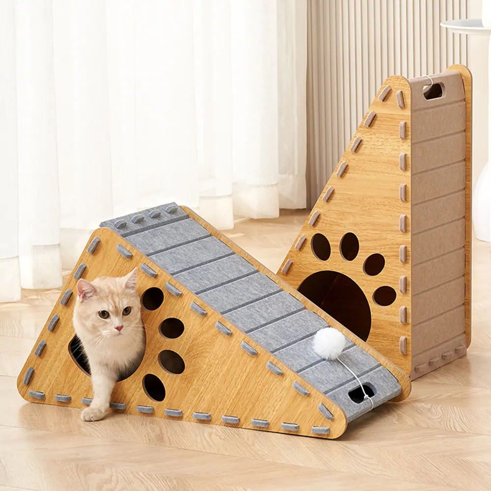 A cat playing with a triangular wooden cat scratcher.