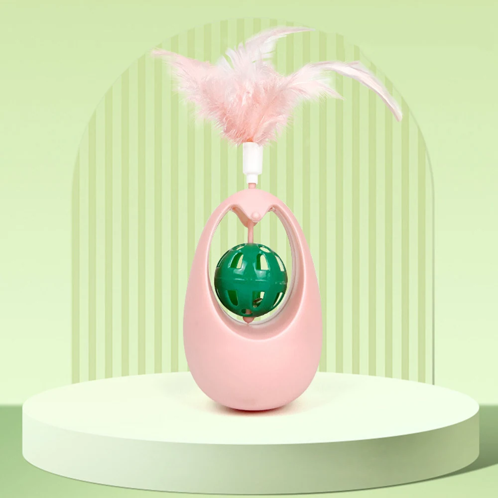 Pink cat toy with a green ball and feather attachment on a display stand