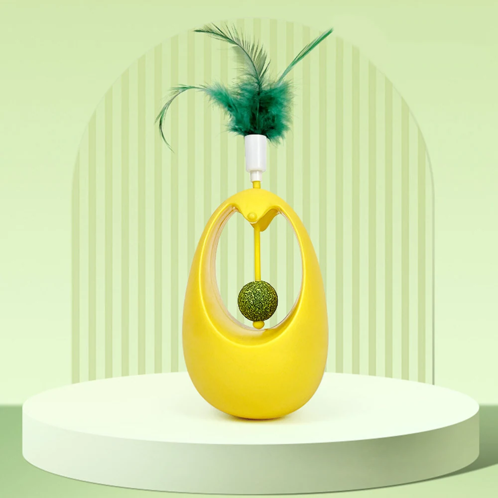 A yellow interactive cat toy with a feather and a ball on a string