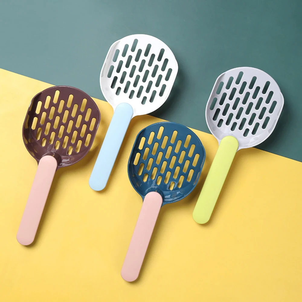 Four plastic mesh food scoops in brown, white, and blue with pastel handles arranged on a yellow and green background