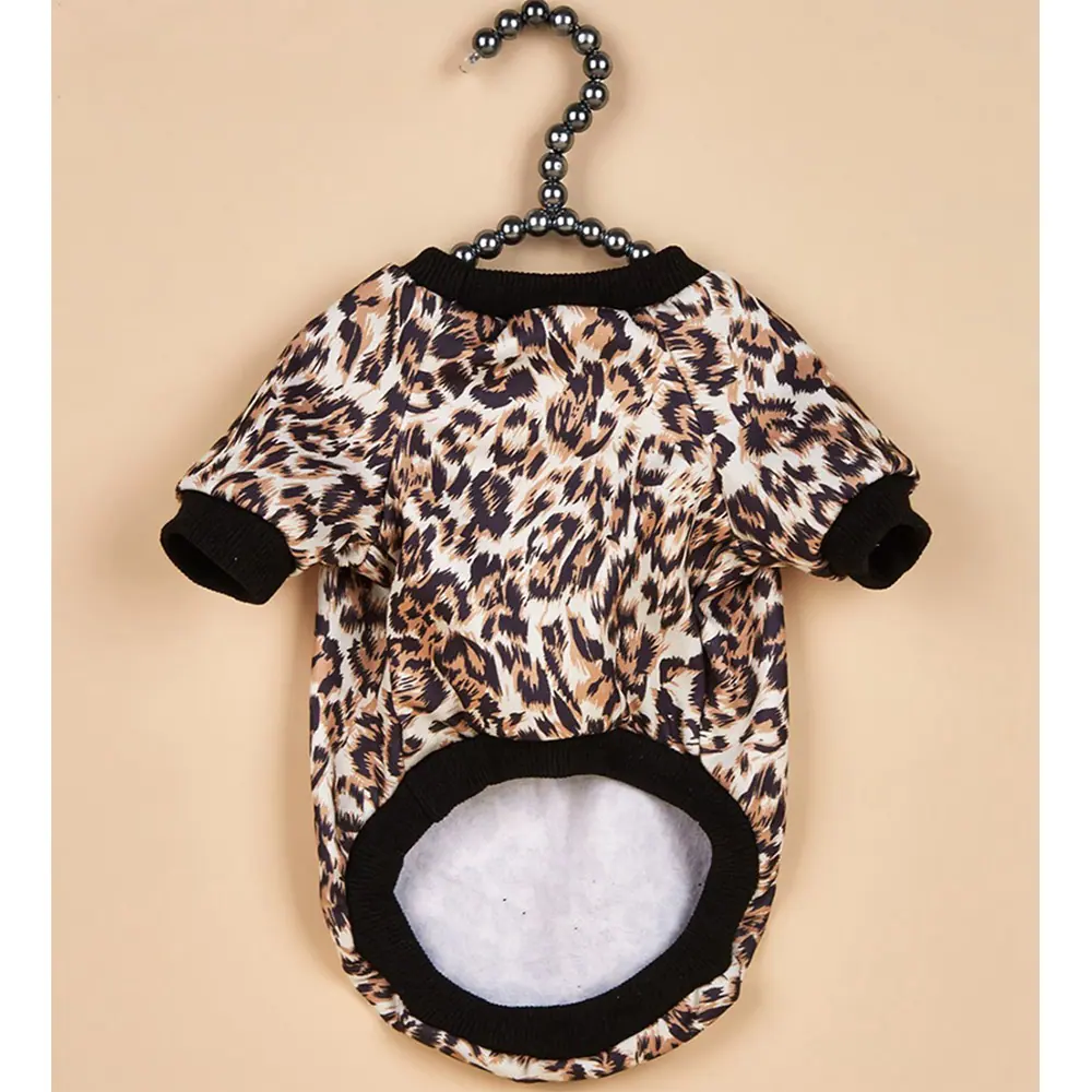 Leopard print fleece dog shirt with black trim hanging on a beaded hanger