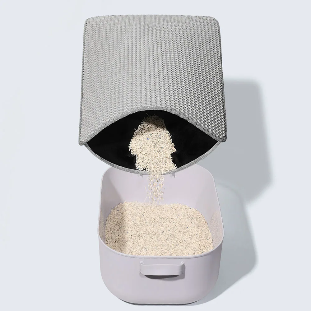 A gray woven basket pouring white grains into a light gray plastic storage bin.